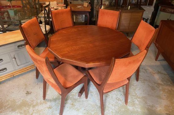 a teak table with six chairs