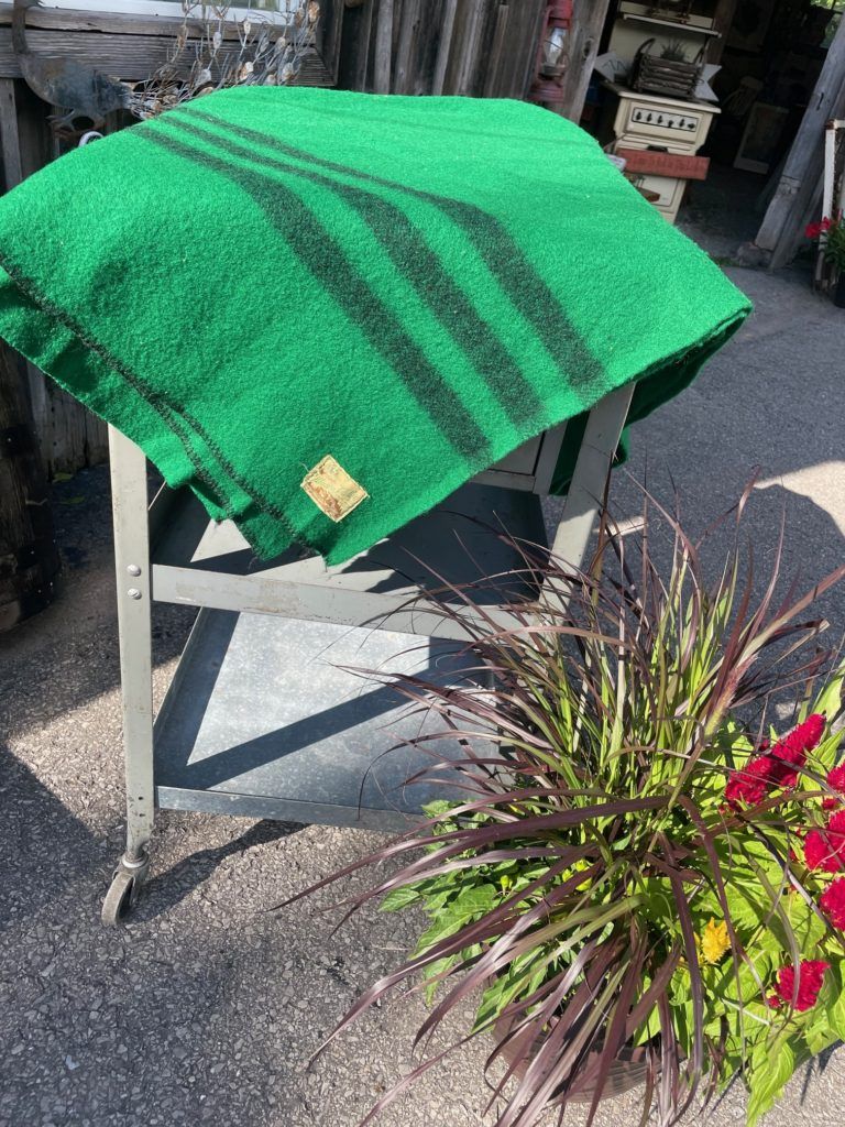 a green blanket with three black stripes