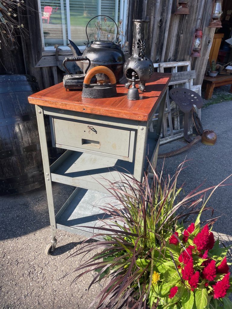 antique kettle and irons on a worktable